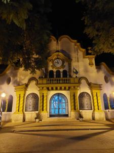a building with a clock on the front of it at Aroma de campo in Chascomús