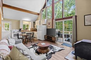 InwoodにあるHot Tub Chalet-Fire Pit Grill Stream & Big Yardのソファとテーブルのあるリビングルーム