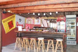 a bar with stools in front of a red wall at Mountain View Eco Lodge Montagu in Montagu