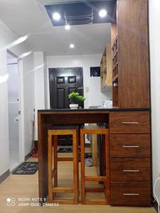 a kitchen with a counter with stools in it at flores staycation in Marilao