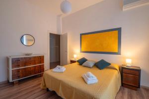 a bedroom with a bed with two towels on it at Piombino Apartments Casa Collodi II in Piombino