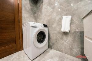 a white washing machine in a bathroom with a towel at Beautiful Holiday Home with Private Rooftop Pool in Mellieħa