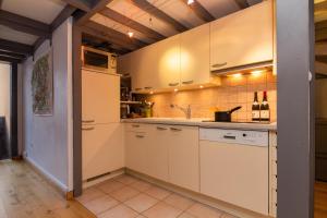 a kitchen with white cabinets and a sink at Résidence Grand Roc - Campanules 314 Happy Rentals in Chamonix-Mont-Blanc
