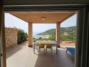 a dining room with a view of the ocean at SERENA-Piscine privée- Vue Mer in Conca