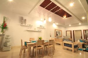 a dining room with a table and chairs at Villa Alam Biru in Sanur