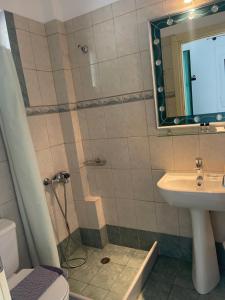 a bathroom with a sink and a toilet and a mirror at Niriides Rooms in Elafonisos