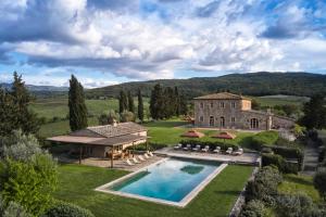 an estate with a swimming pool in front of a building at Castiglion del Bosco, A Rosewood Hotel in Castiglione del Bosco