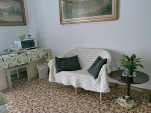 a living room with a chair and a table at SERENDIPITY B&b in Fabriano