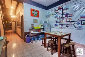 a kitchen with a table and stools in a room at โฟโต้โฮสเทล เบตง Foto Hostel Betong in Betong