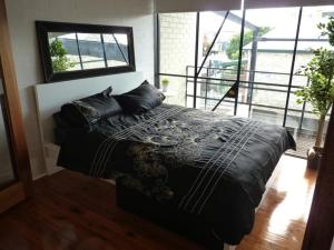 a bedroom with a bed and a large window at Penny's Place in Fremantle