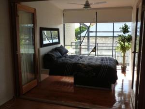 a bedroom with a bed and a large mirror at Penny's Place in Fremantle