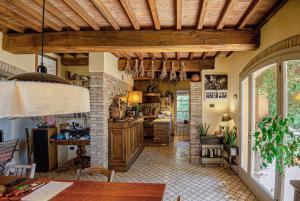 a large kitchen with wooden ceilings and a table at Agriturismo Settesoldi in San Miniato