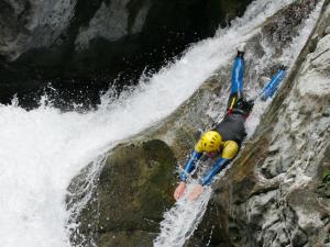 a person on a raft in a waterfall at T2 cabine avec balcon, piscine et parking à Luz-Saint-Sauveur, proche commodités et stations de ski - FR-1-402-140 in Luz-Saint-Sauveur