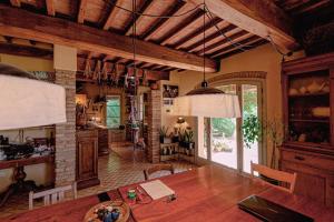 a kitchen and dining room with a wooden table in a room at Agriturismo Settesoldi in San Miniato