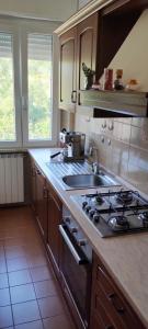 a kitchen with a sink and a stove top oven at La casa di Gianfri in Esanatoglia