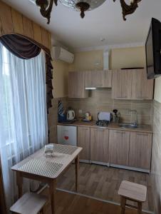 a small kitchen with a table and a sink at Едем in Skhidnitsa