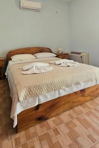 a bedroom with a bed with two towels on it at Villa Nikos in Agios Dimitrios