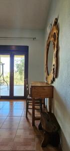 a dining room with a wooden table and a mirror at Villa Nikos in Agios Dimitrios