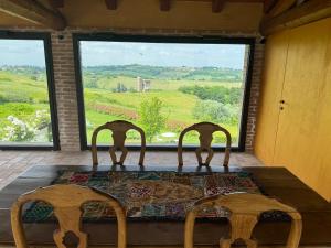 two chairs sitting on a table in front of a window at Glass Apartment Tenuta il Galletto in Casale Monferrato