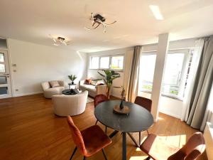 a living room with a table and chairs at Wolu suites in Brussels