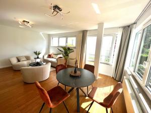 a living room with a table and chairs at Wolu suites in Brussels