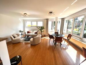a living room with a table and chairs at Wolu suites in Brussels