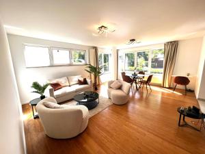 a living room with a couch and chairs and a table at Wolu suites in Brussels