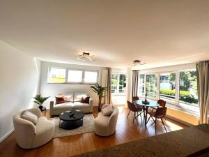 a living room with a couch and chairs and a table at Wolu suites in Brussels
