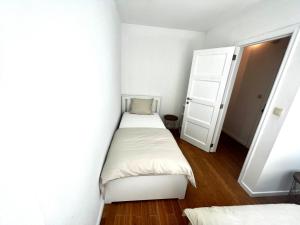 a small bedroom with two beds and a closet at Wolu suites in Brussels