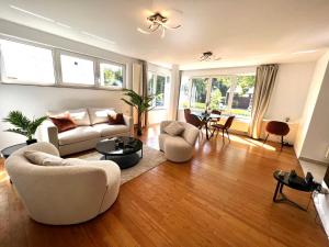 a living room with two couches and a table at Wolu suites in Brussels