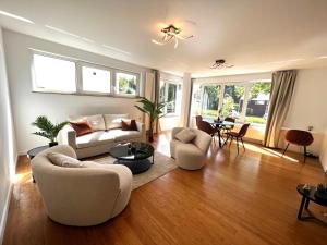 a living room with a couch and chairs and a table at Wolu suites in Brussels