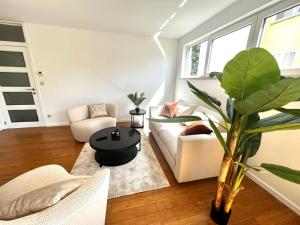 a living room with a couch and a table at Wolu suites in Brussels
