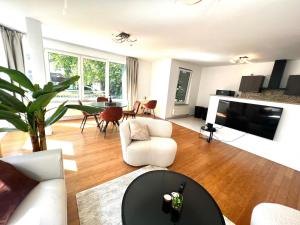 a living room with a couch and a table at Wolu suites in Brussels