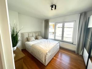 a bedroom with a bed and a large window at Wolu suites in Brussels