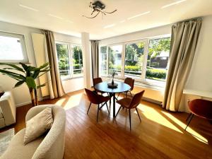 a living room with a table and chairs and windows at Wolu suites in Brussels +37 photos