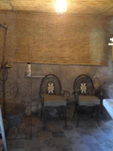 two chairs and a table in a room at ViLA VELLA 1 in Santa Pau +6 photos