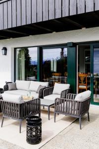 a group of chairs and tables on a patio at Cottage Salzburg in Nußdorf am Haunsberg