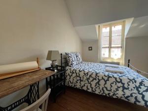 a small bedroom with a bed and a window at Maison de caractere cœur du village 1h de Paris in Montigny-sur-Loing