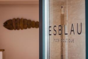 a sign on a window with a sausage on it at Hotel Boutique Es Blau in Cadaqués