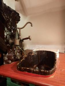 a bathroom sink with a faucet on a table at Rustic Charm a Unique and Antique Apartment in Zagreb