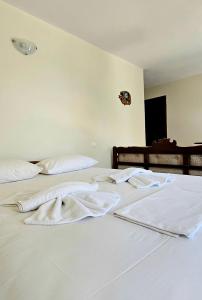 two white towels sitting on top of a bed at Villa Dimitra in Agios Dimitrios