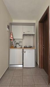 a small kitchen with a sink and a stove at Villa Dimitra in Agios Dimitrios