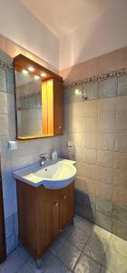 a bathroom with a sink and a mirror at Villa Dimitra in Agios Dimitrios