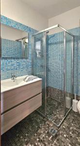 a bathroom with a shower and a tub and a sink at Villa Dimitra in Agios Dimitrios
