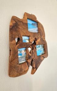 a piece of wood with pictures on a wall at Villa Dimitra in Agios Dimitrios