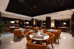 a dining room with tables and chairs and tablesktop at Travancore Court in Cochin