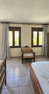 a living room with a couch and two windows at Villa Dimitra in Agios Dimitrios