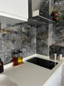a kitchen with black and white marble walls at BiSuite Urla in Kuscular +80 photos