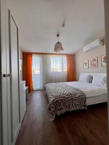 a bedroom with a bed with a zebra blanket on it at BiSuite Urla in Kuscular