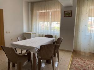 a dining room with a white table and chairs at Apartament Techirghiol in Techirghiol